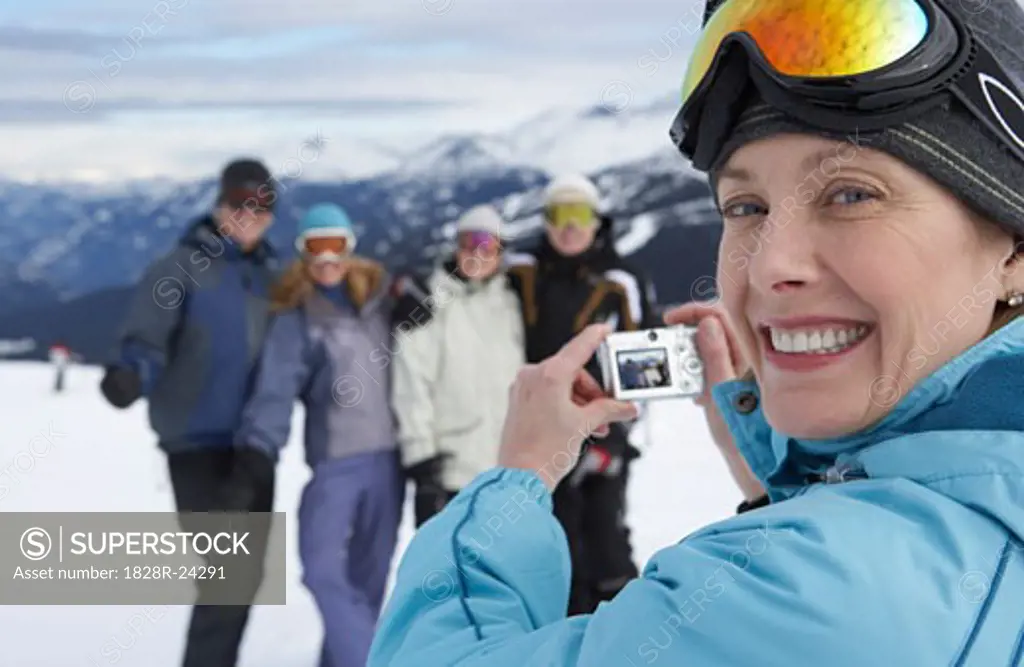 Woman Taking Picture on Ski Hill, Whistler, BC, Canada   
