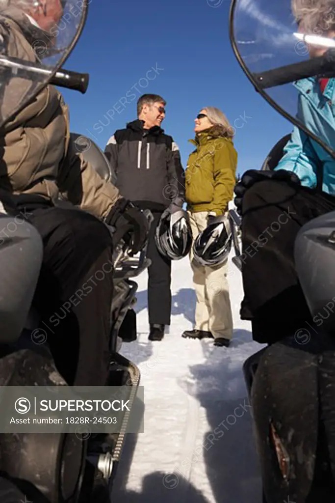 People Snowmobiling   