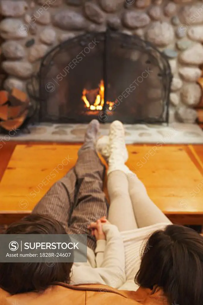 Couple Sitting in Front of Fireplace   