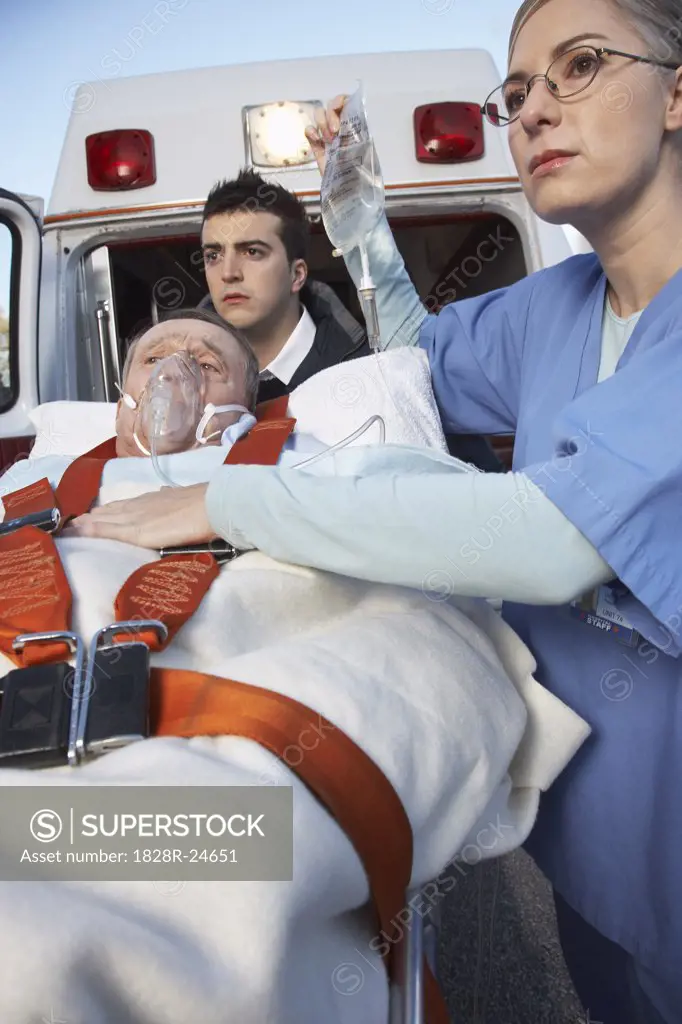 Paramedic and Doctor with Patient on Stretcher   