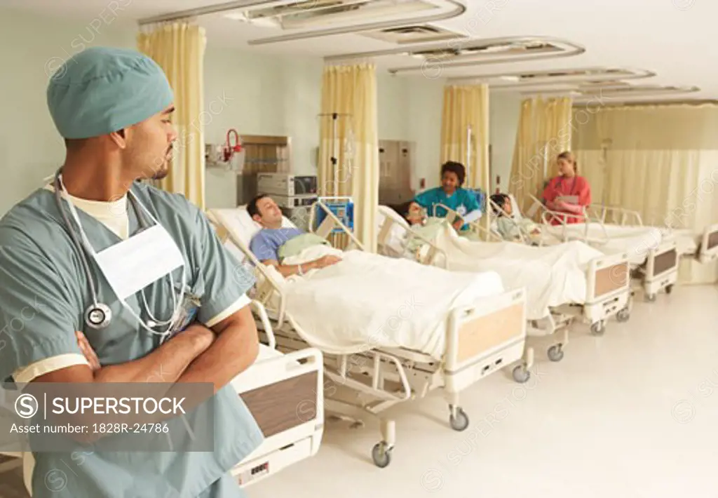 Nurses Tending to Patients while Doctor Watches   