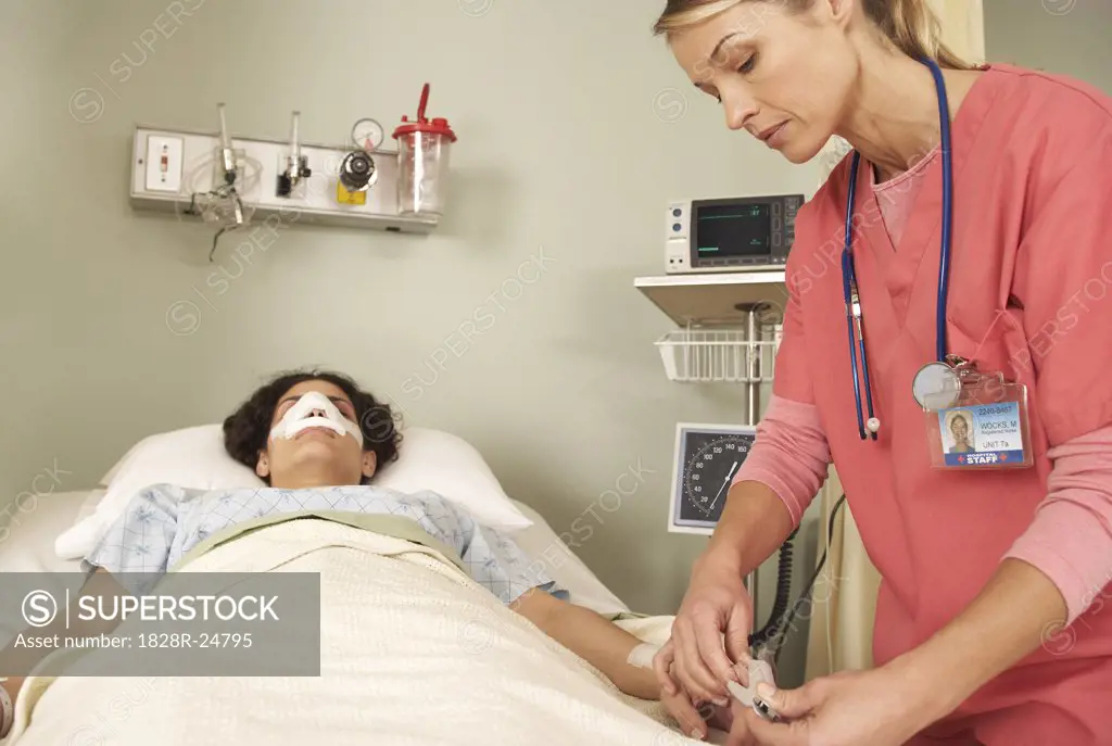 Nurse Checking Patient's Oxygen Monitor   