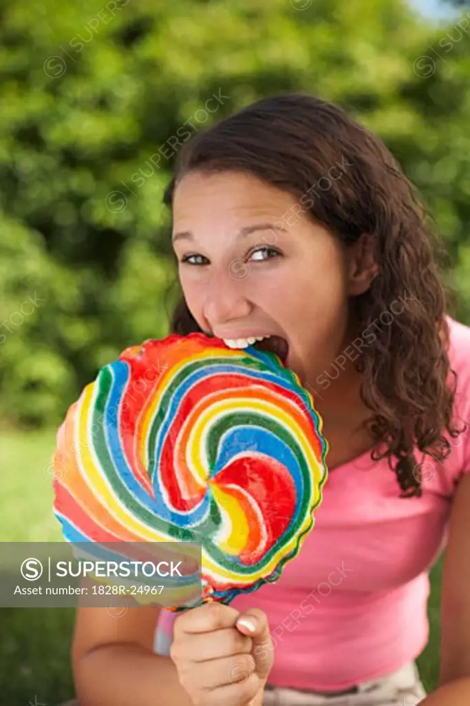 Teenage Girl Biting Lollipop   