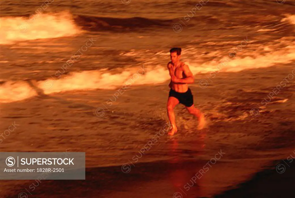 Man Running in Surf on Beach   