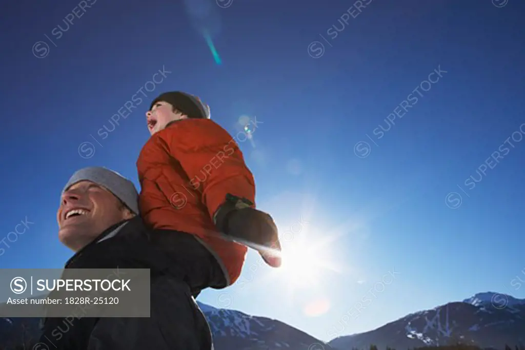 Father Giving Son Piggyback Ride   