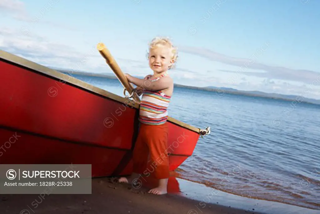 Girl Standing by Rowboat   