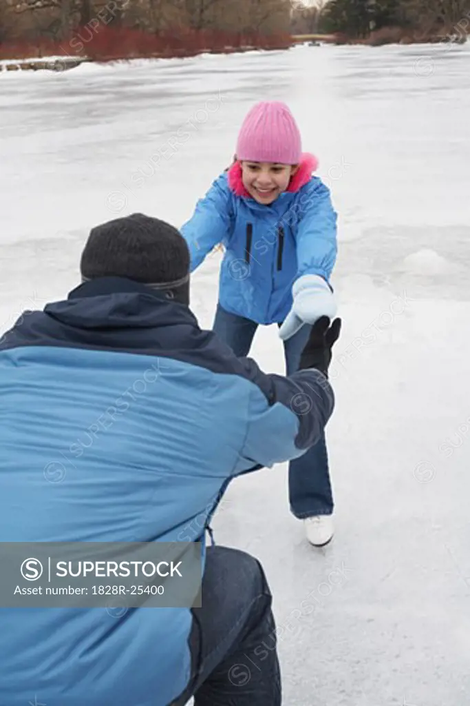 Father Teaching Daughter to Skate   