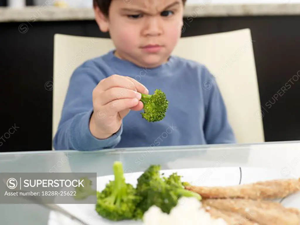 Boy Staring at Broccoli   