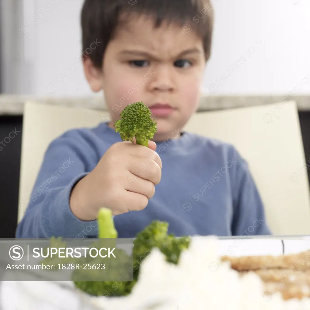 Boy Staring at Broccoli   