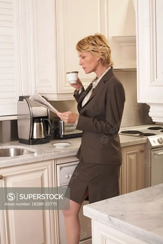 Businesswoman with Newspaper and Coffee   