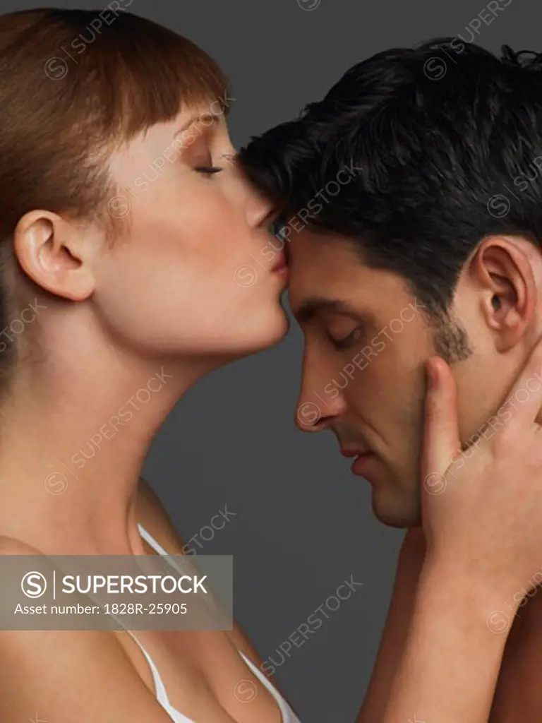 Woman Kissing Man's Forehead   
