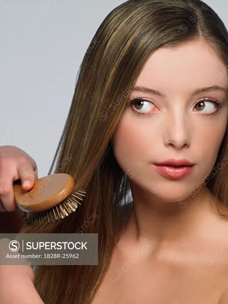 Young Woman Brushing Hair   