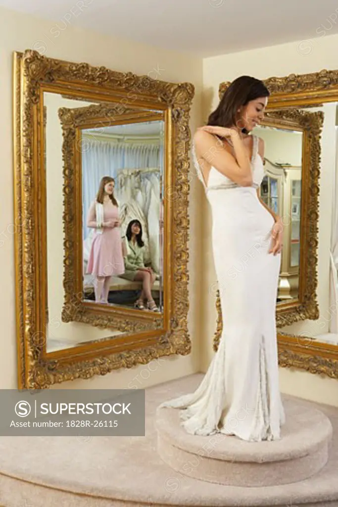 Woman Trying on Wedding Gown   