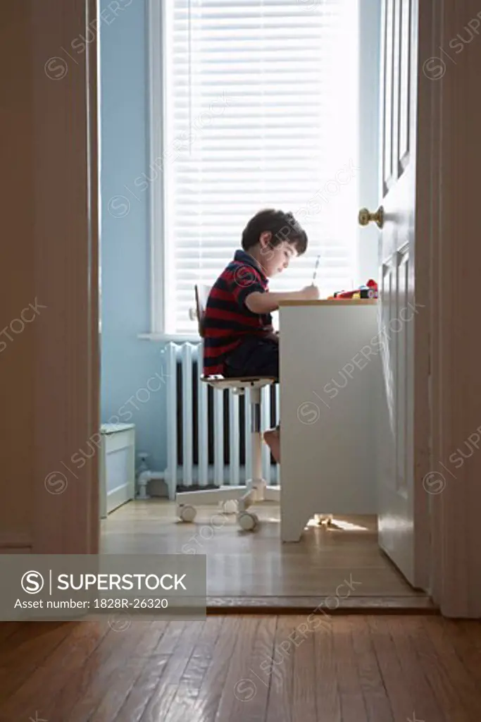 Boy at Desk in Bedroom   