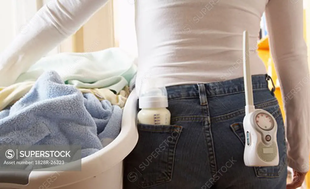 Woman with Laundry Basket and Baby Monitor   
