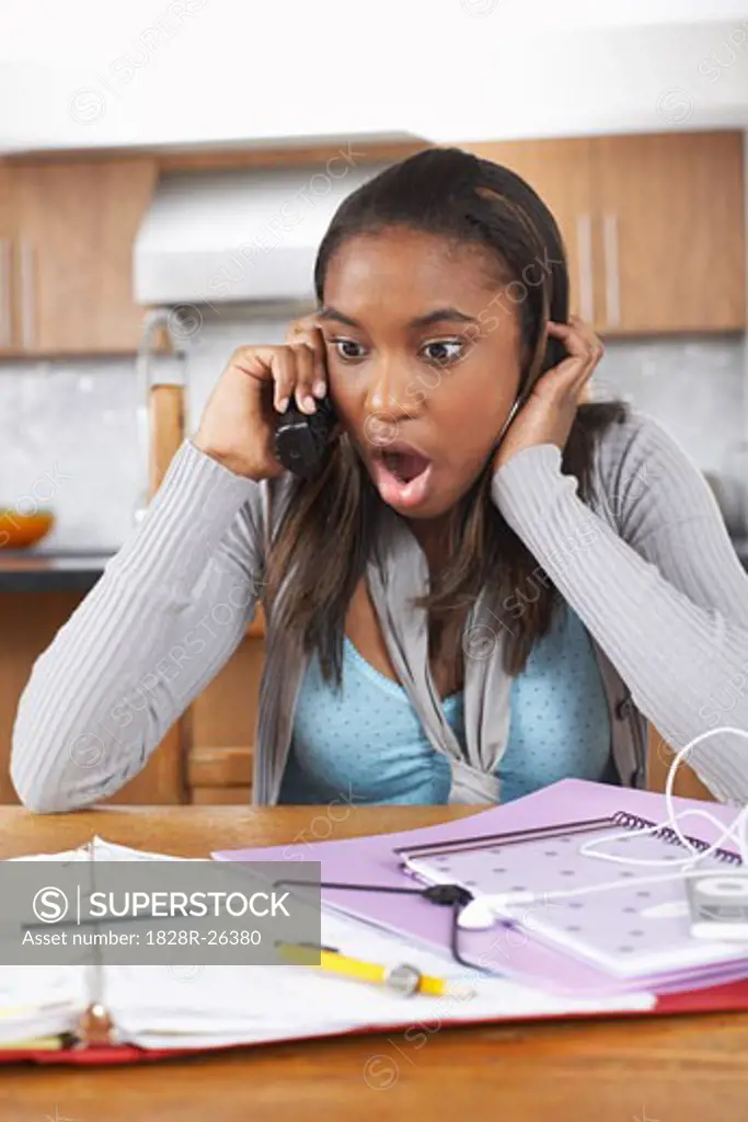 Girl with Homework Talking on Phone   