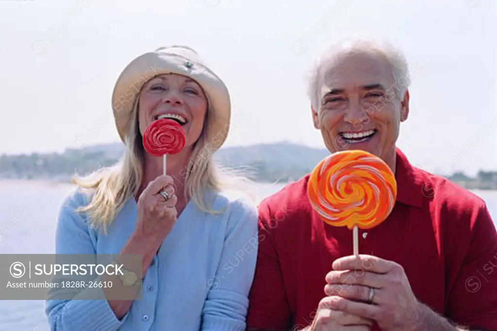 Portrait of Couple Eating Lollipops   