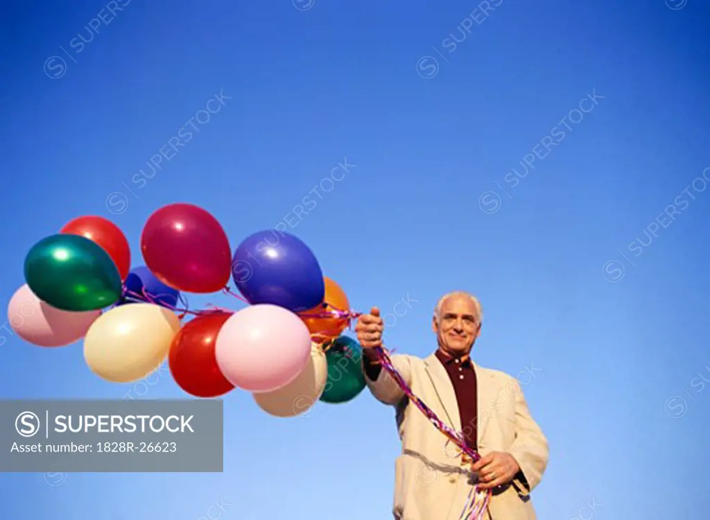Man Holding Bunch of Balloons   