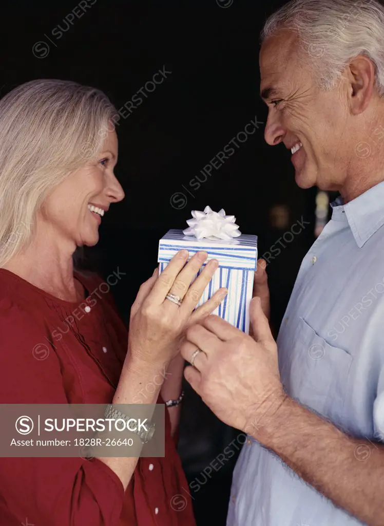 Portrait of Couple holding Gift   