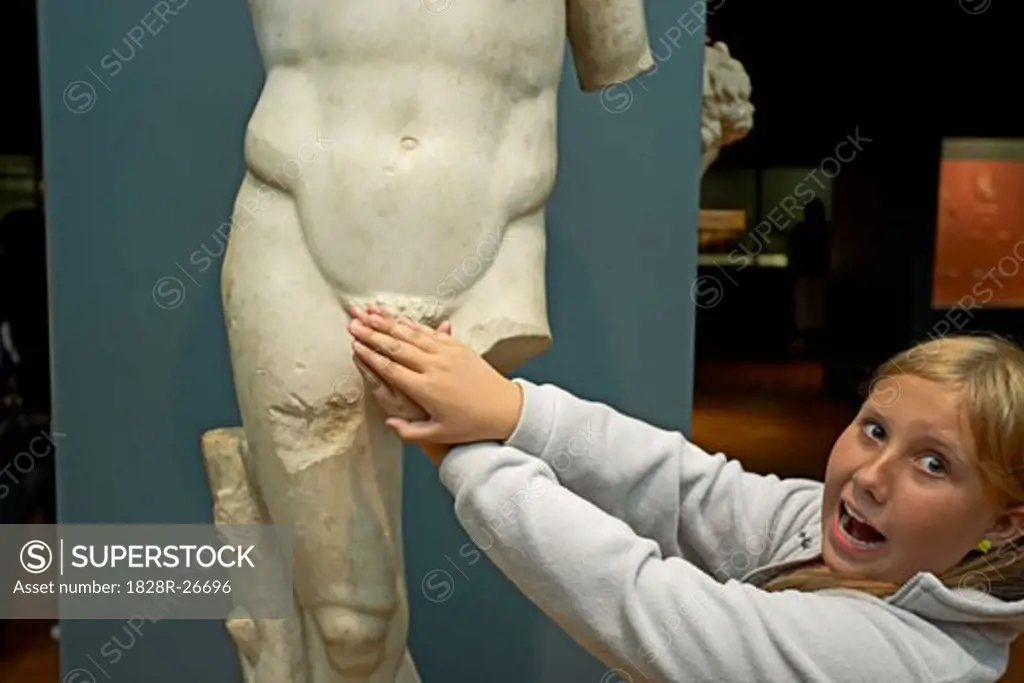Girl Covering Up Statue of Nude Man   