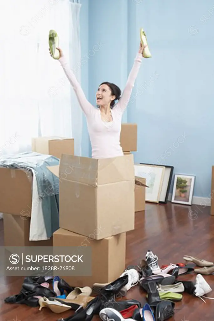 Woman Unpacking Shoes in New Home   