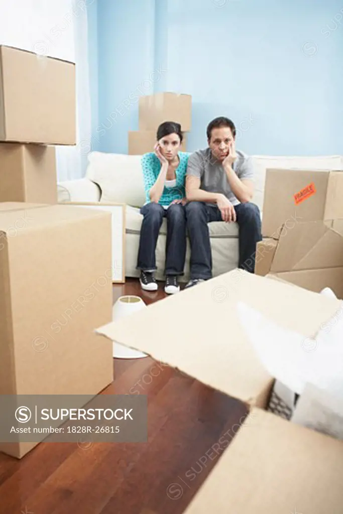 Couple Sitting on Sofa in New Home   