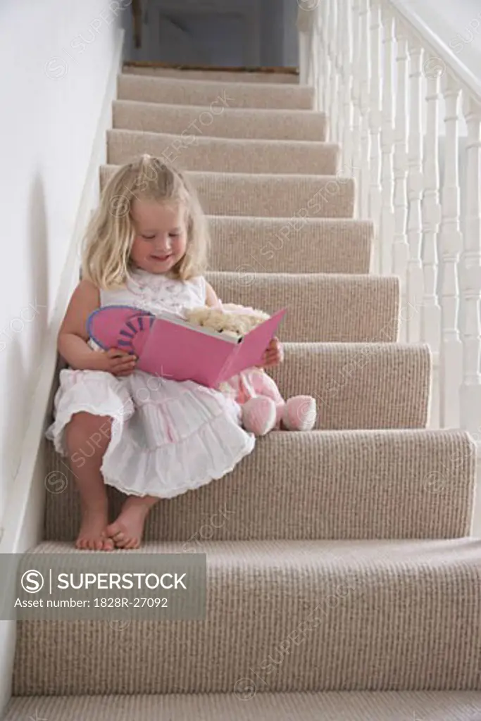 Girl Reading Book on Staircase   