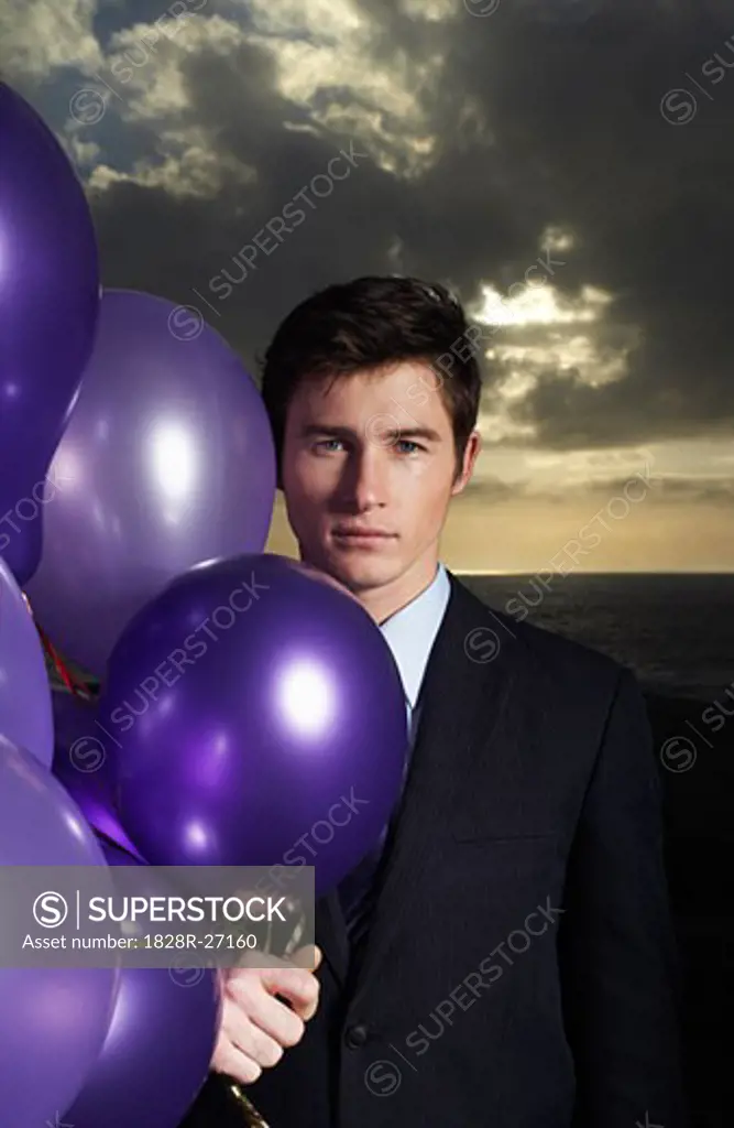 Businessman Holding Balloons   