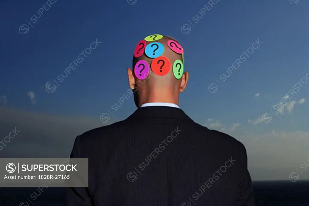Businessman with Question Marks   