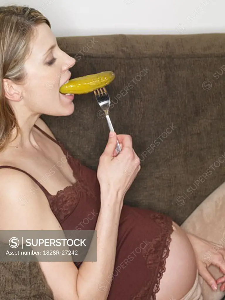 Pregnant Woman Eating Pickle   