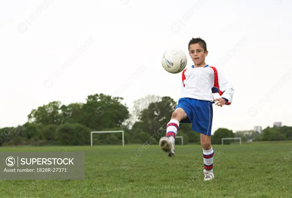 Boy Playing Soccer   