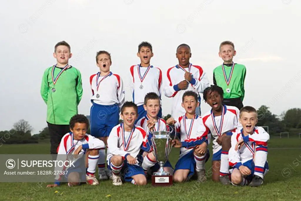 Portrait of Soccer Team With Gold Medals and Trophy   