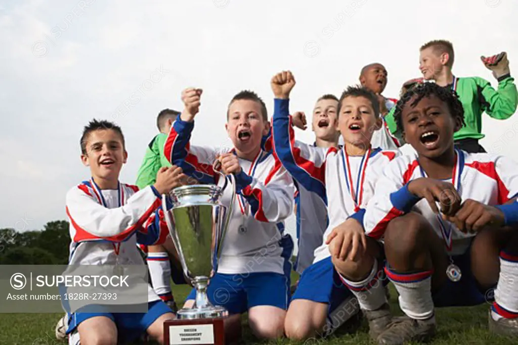 Soccer Team With Gold Medals and Trophy   