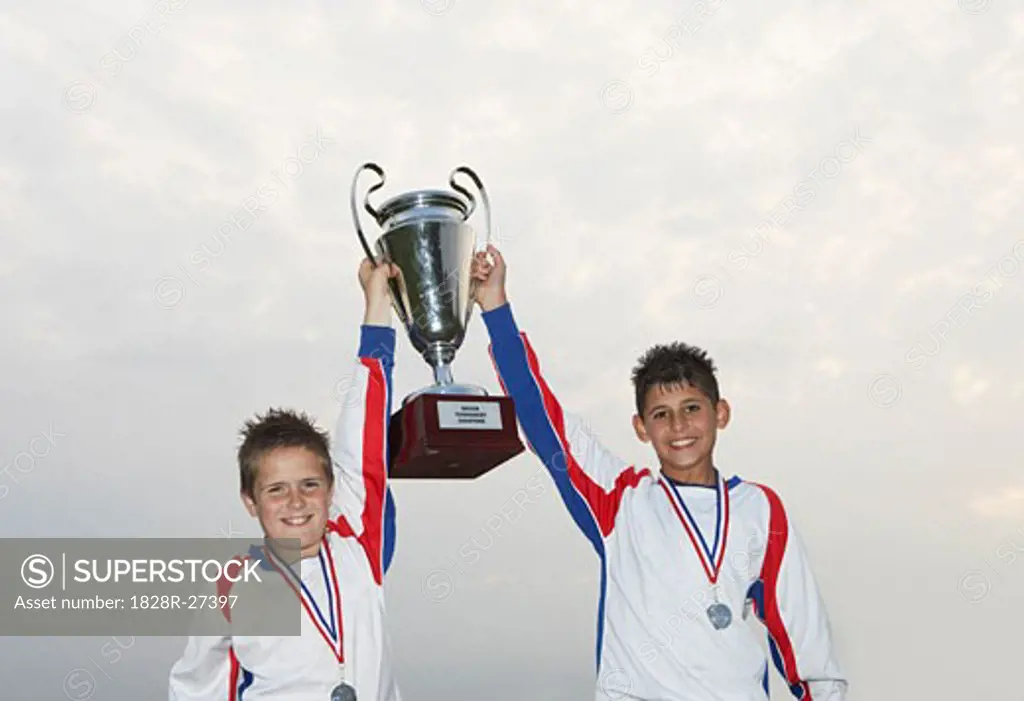 Soccer Players With Gold Medals and Trophy   