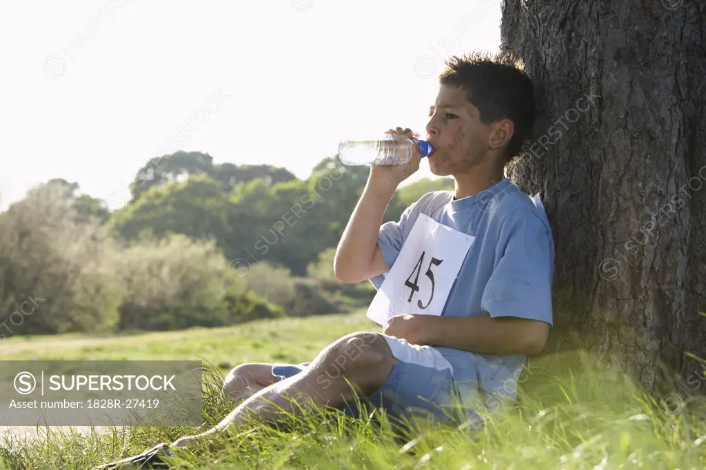 Boy Drinking Water After Race   