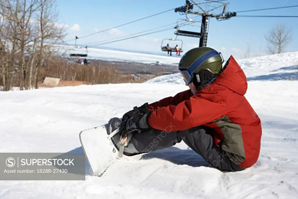 Boy on Ski Hill with Snowboard, Blue Mountain, Collingwood, Ontario, Canada   