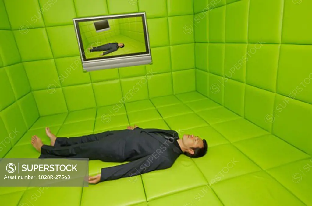Man Lying on Back in Green Padded Room with Telelvision   