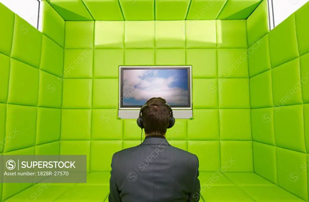 Man Watching Television in Green Padded Room   