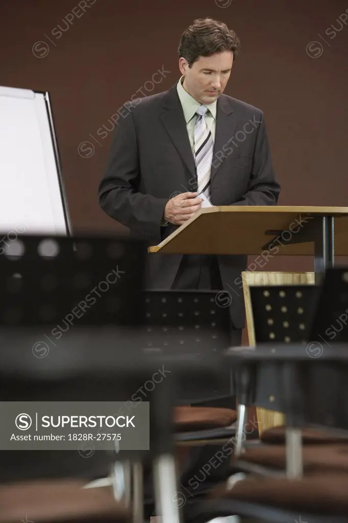 Businessman at Lecturn in Boardroom   