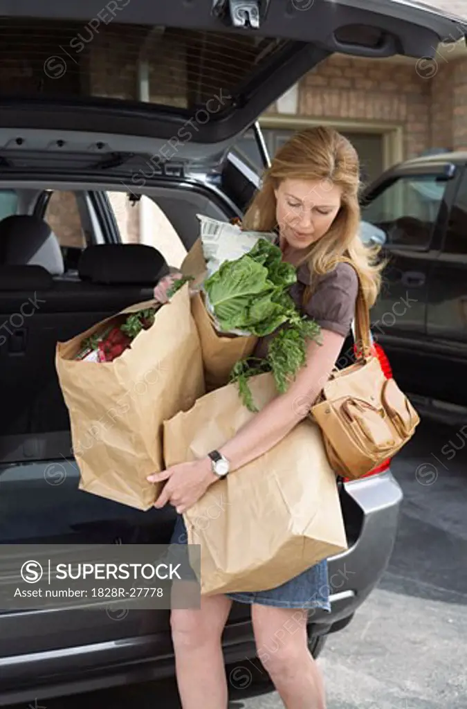 Woman Removing Groceries from Car   