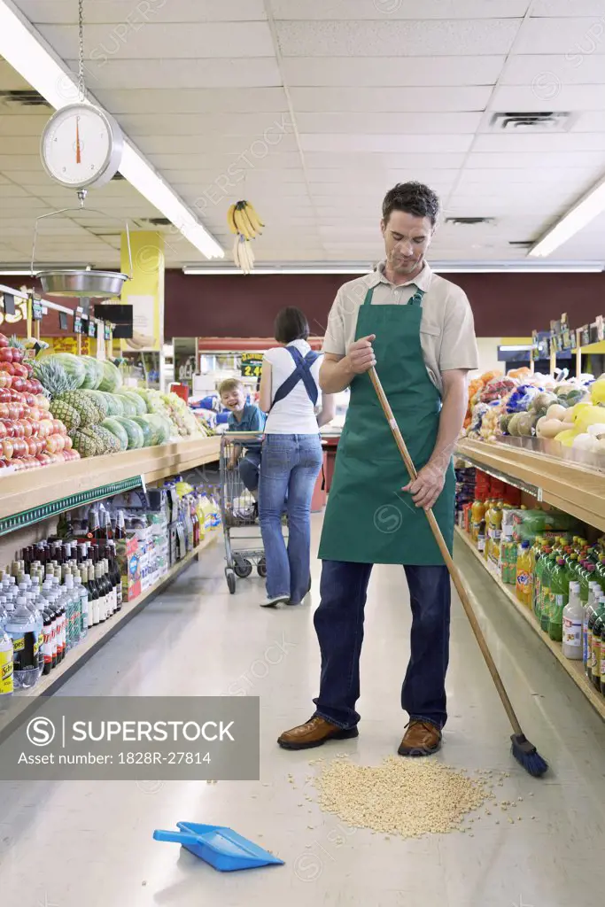 Sales Associate in Grocery Store Cleaning Aisle   