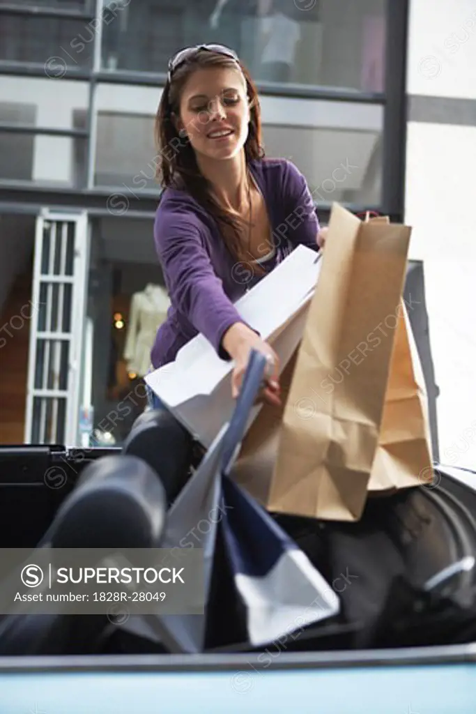 Woman Carrying Shopping Bags to Car   