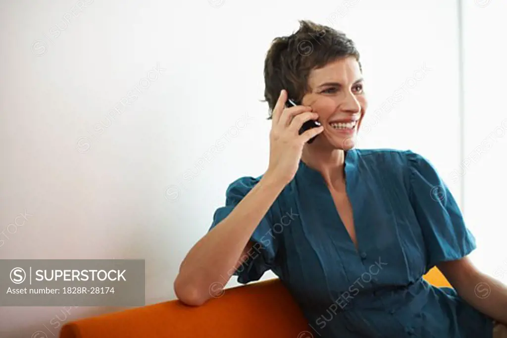Woman with Cellular Phone on Sofa   