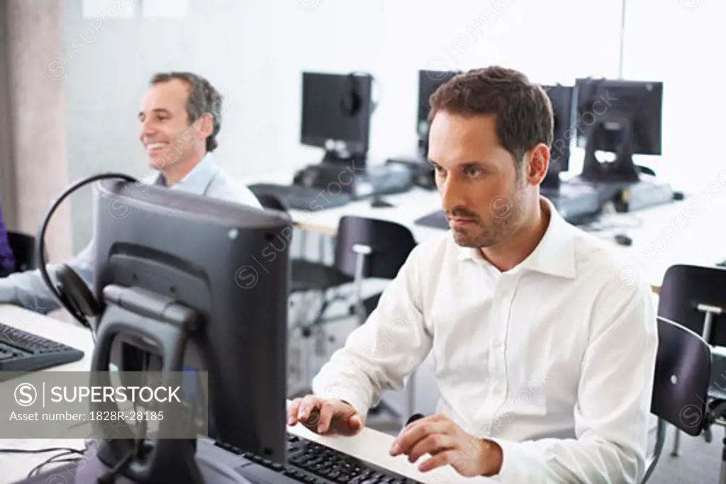 Men Working on Computers in Office   