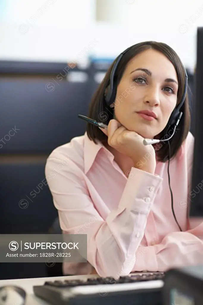 Businesswoman Working on Computer with Headset   