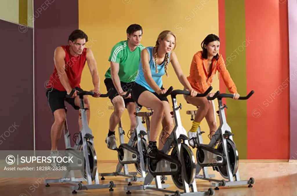 Group of People Using Exercise Bicycles   