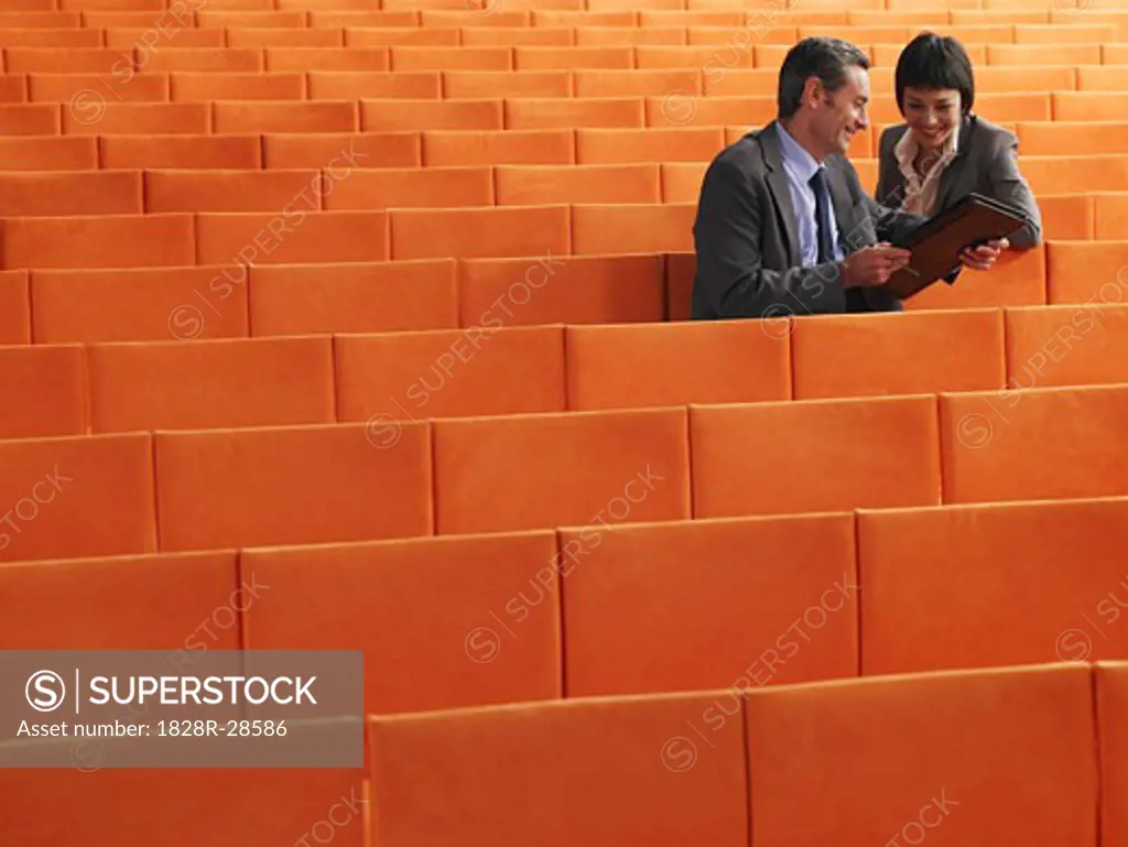 Business People  Sitting in Auditorium   