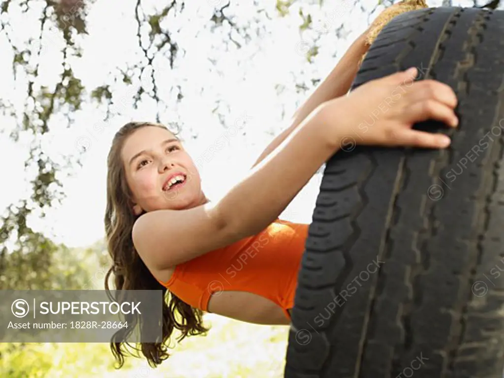 Girl Swinging on Tire Swing   