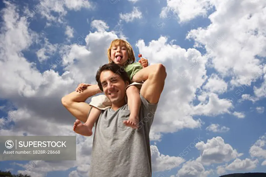 Boy Riding on Father's Shoulders   