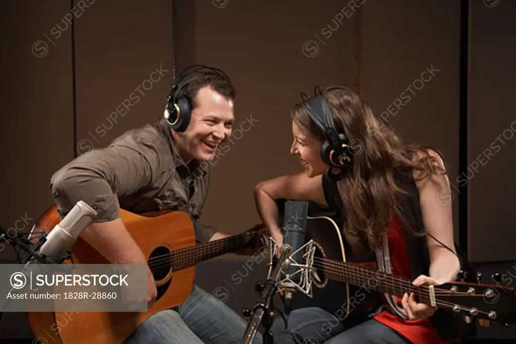 Musicians Playing Guitar in Recording Studio   